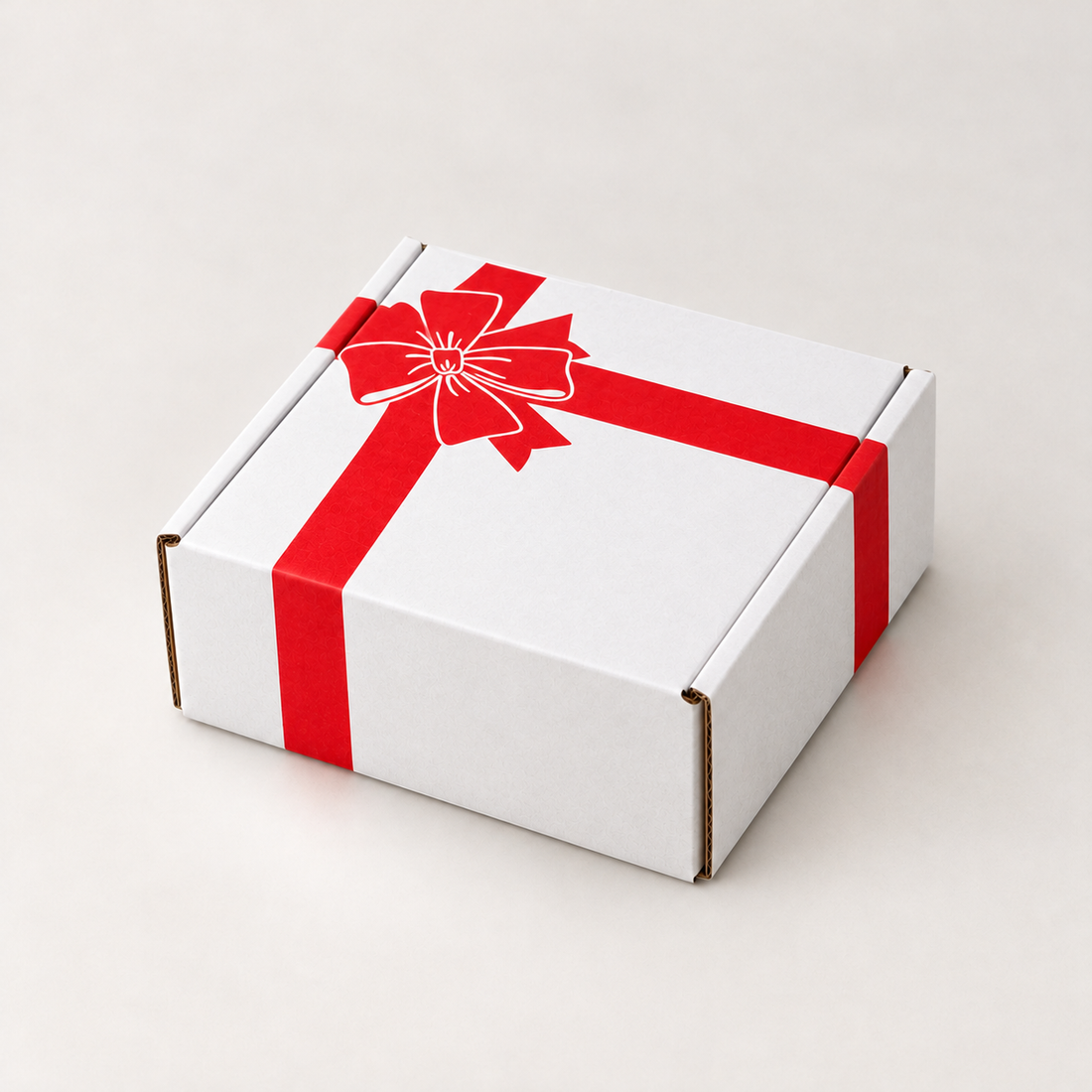 A square white cardboard gift box with a red ribbon printed or wrapped across the top and sides, tied in a bow, shown on a clean light beige studio background.